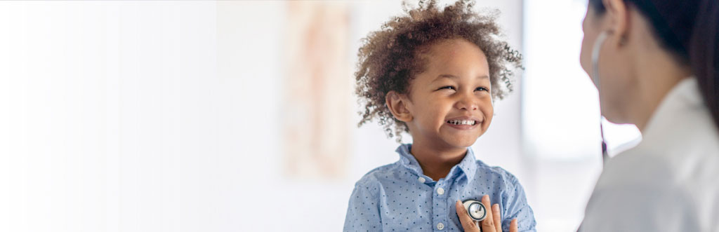 Doctor treating happy boy