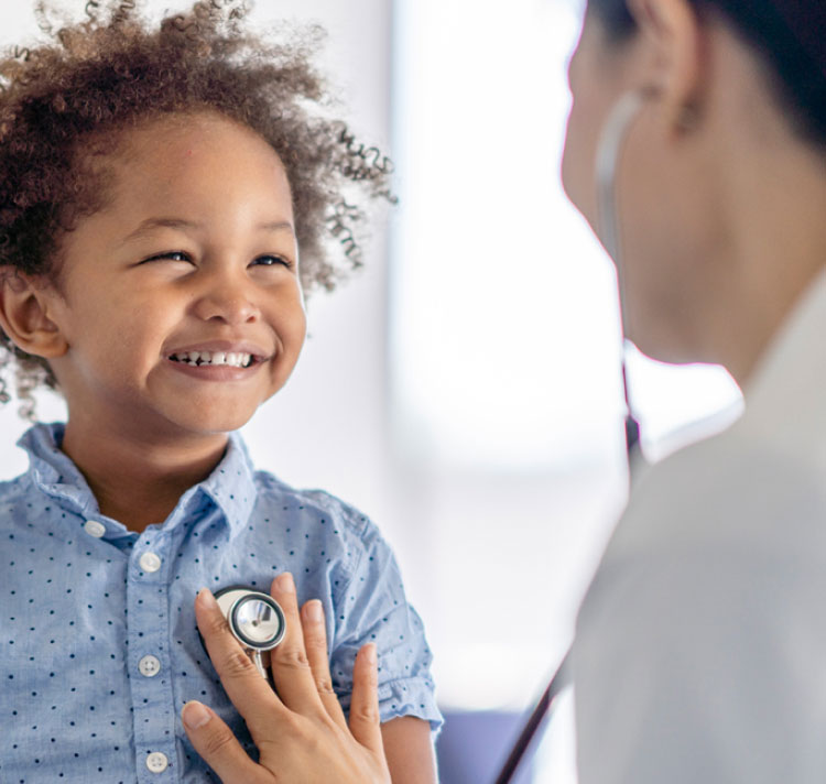 Doctor treating happy boy